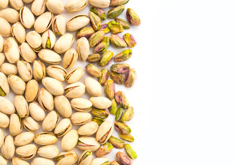 Roasted pistachio nuts on a white background and place for inscription