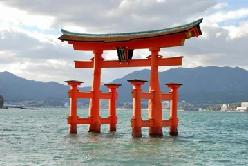 Foto op Plexiglas Traditional Japanese torii gate floating in a tranquil body of water in Itsukushima. © Wirestock