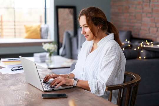 Young freelancer woman using laptop working online in the home office