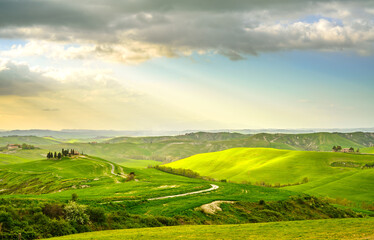 Fototapeta premium Tuscany, rural sunset landscape. Countryside farm, white road and cypress trees.