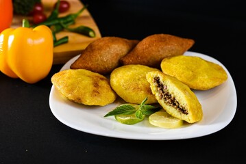 Naklejka na ściany i meble Kibbeh is a family of dishes based on spiced ground meat, onions, and grain, popular in Middle Easte