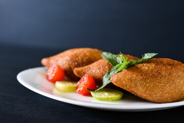 Kibbeh is a family of dishes based on spiced ground meat, onions, and grain, popular in Middle Easte