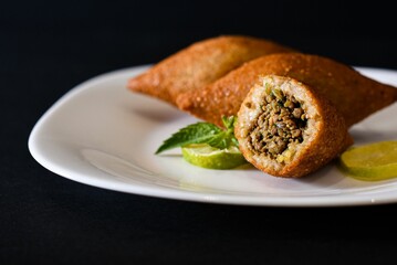 Kibbeh is a family of dishes based on spiced ground meat, onions, and grain, popular in Middle Easte
