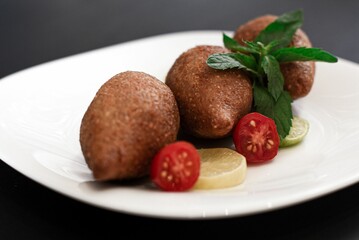 Kibbeh is a family of dishes based on spiced ground meat, onions, and grain, popular in Middle Easte