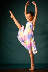 a girl dressed in a colorful dress, doing a split © Wirestock