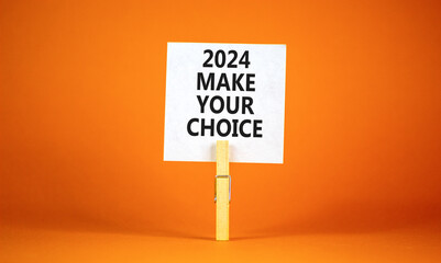 2024 Make your choice symbol. Concept words 2024 Make your choice on beautiful white paper on clothespin. Beautiful orange background. Business 2024 Make your choice concept. Copy space
