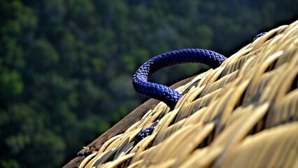 a close up of a woven rope on the top of a building