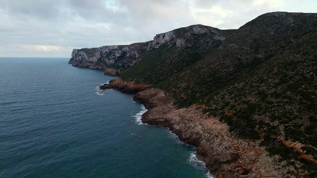 Landscape aerial scene of green cliffs of Robberg Hiking Trail blue sky in South Africa