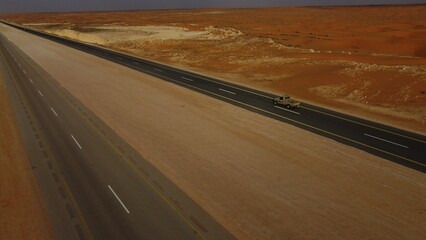 Closeup of the road in the middle of the desert in Saudi Arabia on a sunny day