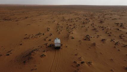 Aerial view of a white, vintage located in the desert of Saudi Arabia