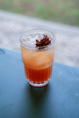 Coctail Drink with Red Color in a Big Glass with Rosella Flower on top as Garnish