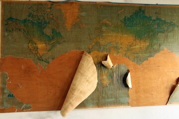 paper cones are sitting on top of a bulletin board with a world map on it