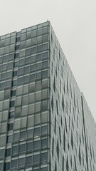 Modern glass skyscraper stands tall in an urban landscape