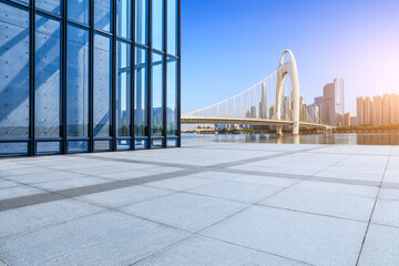 Empty square floor and glass wall with city buildings in Guangzhou - obrazy, fototapety, plakaty