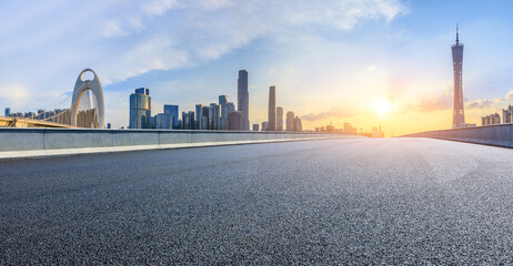 Asphalt highway road and modern city buildings at sunset in Guangzhou. Panoramic view.