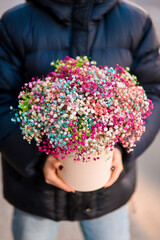 Focus on a delicate bouquet of multi-colored gypsophila in a gift box