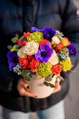 Close up of a spicy bouquet of colorful flowers in a gift box