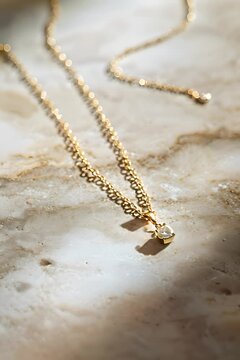 a close up of a necklace on a marble surface