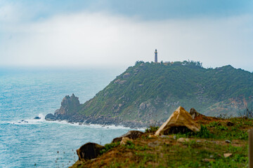 Lighthouse on the mountain.
Cloudy weather, clouds in the sky. Not far from Nha Trang in Vietnam.