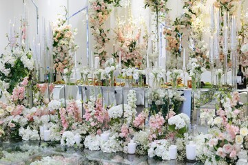 a large table with lots of flowers and candles on it