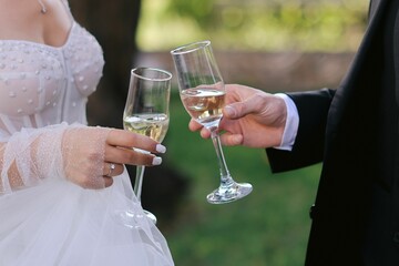 a bride and a groom holding a glass of champagne