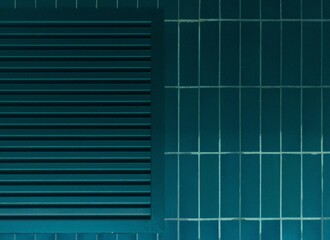 Blue tiled wall with a long rectangular rows at the top, framed by metal bars