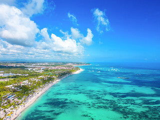 High aerial view of the Punta Cana coast with many all inclusive hotels. Large white sand beach and...