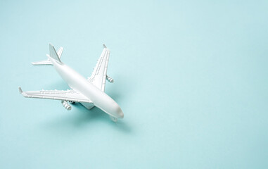 White airplane on the  blue background. Vacation travel concept.