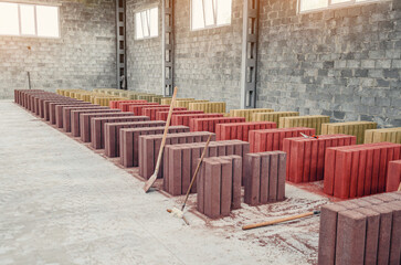 Drying of finished paving stones at factory. Concrete palisades. Colored paving stones