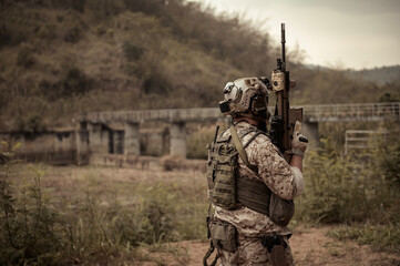 Soldiers  in camouflage uniforms aiming with their rifles.ready to fire during Military Operation...