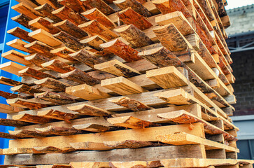Planks made of pine wood are stacked to dry