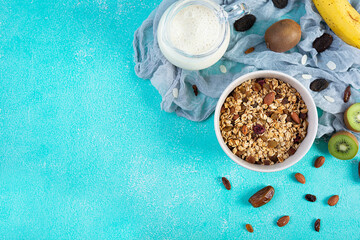 Obraz na płótnie Canvas Bowl of granola with nuts, berries and yogurt. Muesli oats with fruits