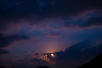 Moonlight in Cloudscape at Night in Lugano, Ticino, Switzerland.