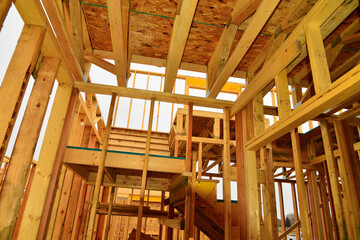 Interior wood framework of single family residential building under construction.