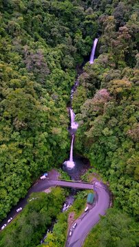 Drone of La Paz Waterfall streaming from mountain covered by vegetation in Cinchona, Costa Rica