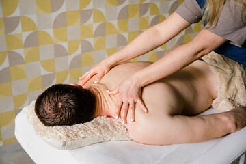 Obraz na płótnie Canvas Tranquil Massage Session: Man Receives Massage on Couch