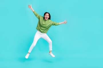 Fototapeta na wymiar Full size photo of cheerful astonished lady raise hands open mouth isolated on turquoise color background
