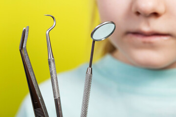 Dental instruments against the background of the mouth of a seven-year-old girl. Surgical dentistry...