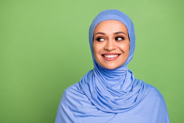 Photo of lovely arab woman interested minded look empty space inspiration isolated over green color...