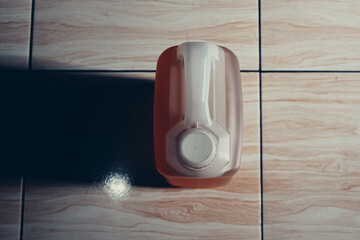 a plastic jerrycan filled with cooking oil stood on the floor