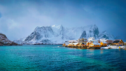 Panorama of yellow rorbu houses of Sakrisoy fishing village with snow in winter. Lofoten islands, Norway - 768864519