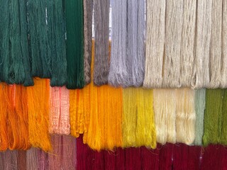 Silk threads are plucked from silkworms in Thailand.