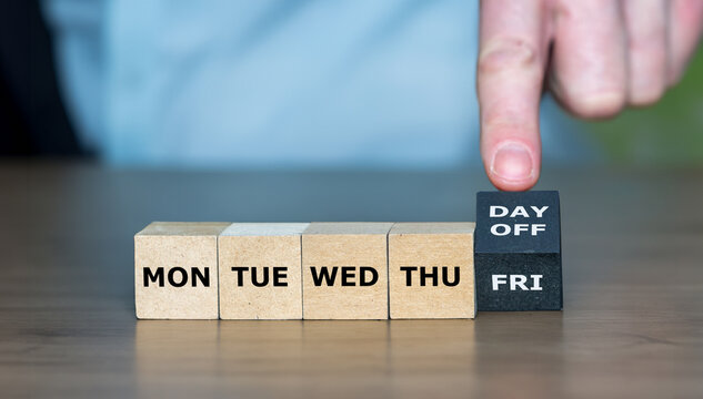 Symbol for a 4 day work week. Hand turns cube and changes the expression 'FRI' to 'day off'.