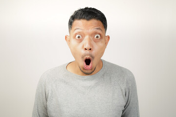surprised, shocked expression of Asian Man, with his mouth open and wide open eyes, isolated...