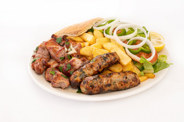 Cypriot Seftalia and Pork Chopped meal with fries and salad