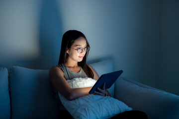 Housewife read on tablet computer with glasses at home