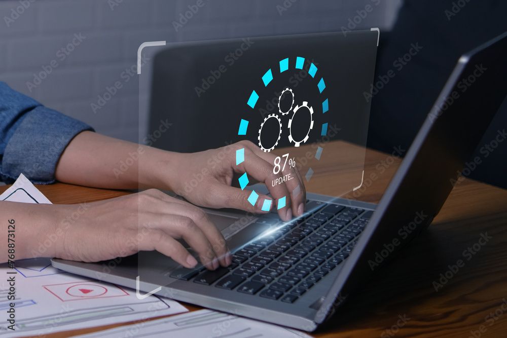 Fototapete Businesswoman updating computer system software application for device to be up to date with new version. Graphics icon updating function screen loading on computer laptop.