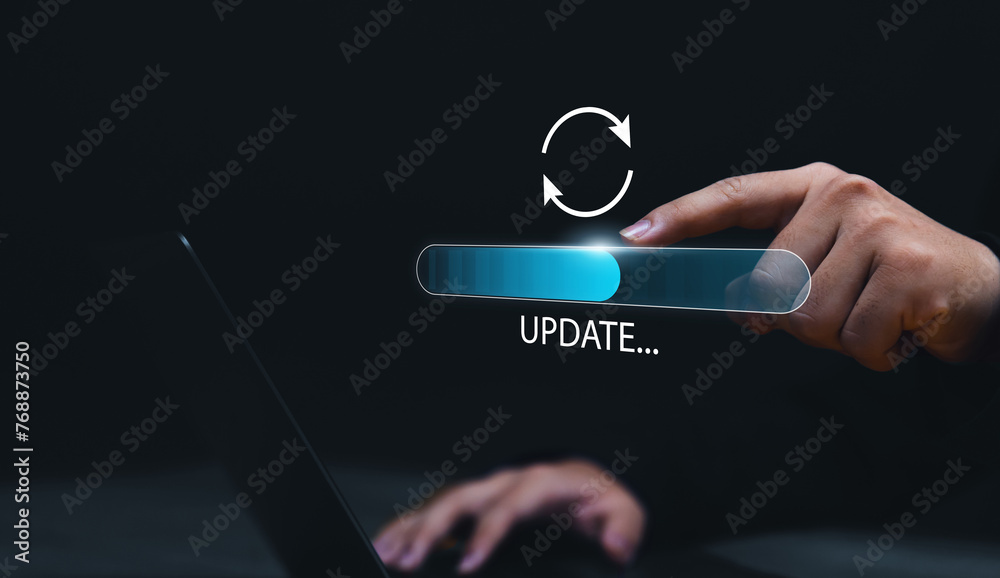 Fototapete Updating computer system software application installation for devices to be up to date with the new version. Hand interacting with graphics icon updating function screen loading on computer laptop.