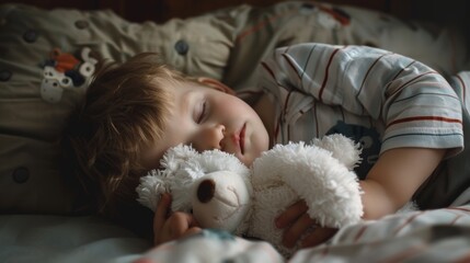 A little boy snuggling close to his favorite white bear toy, fast asleep in his pajamas