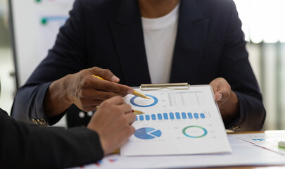 Meeting to analyze business strategies and plan investments. Financial advisor discusses statistical data analysis.